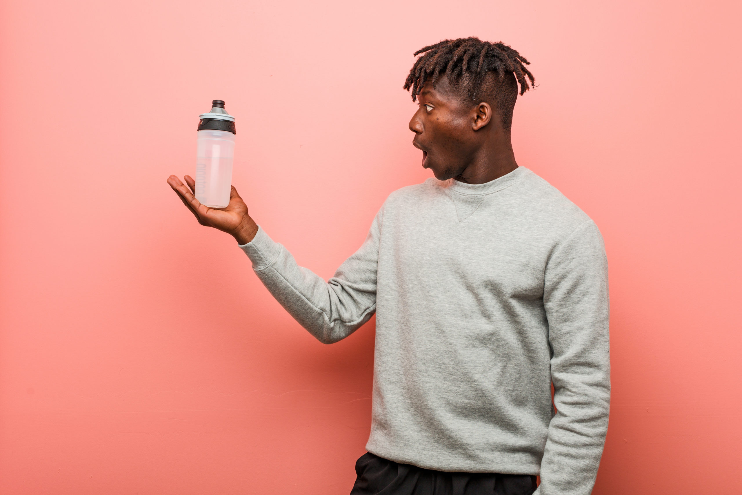 Black man holding a water bottle.