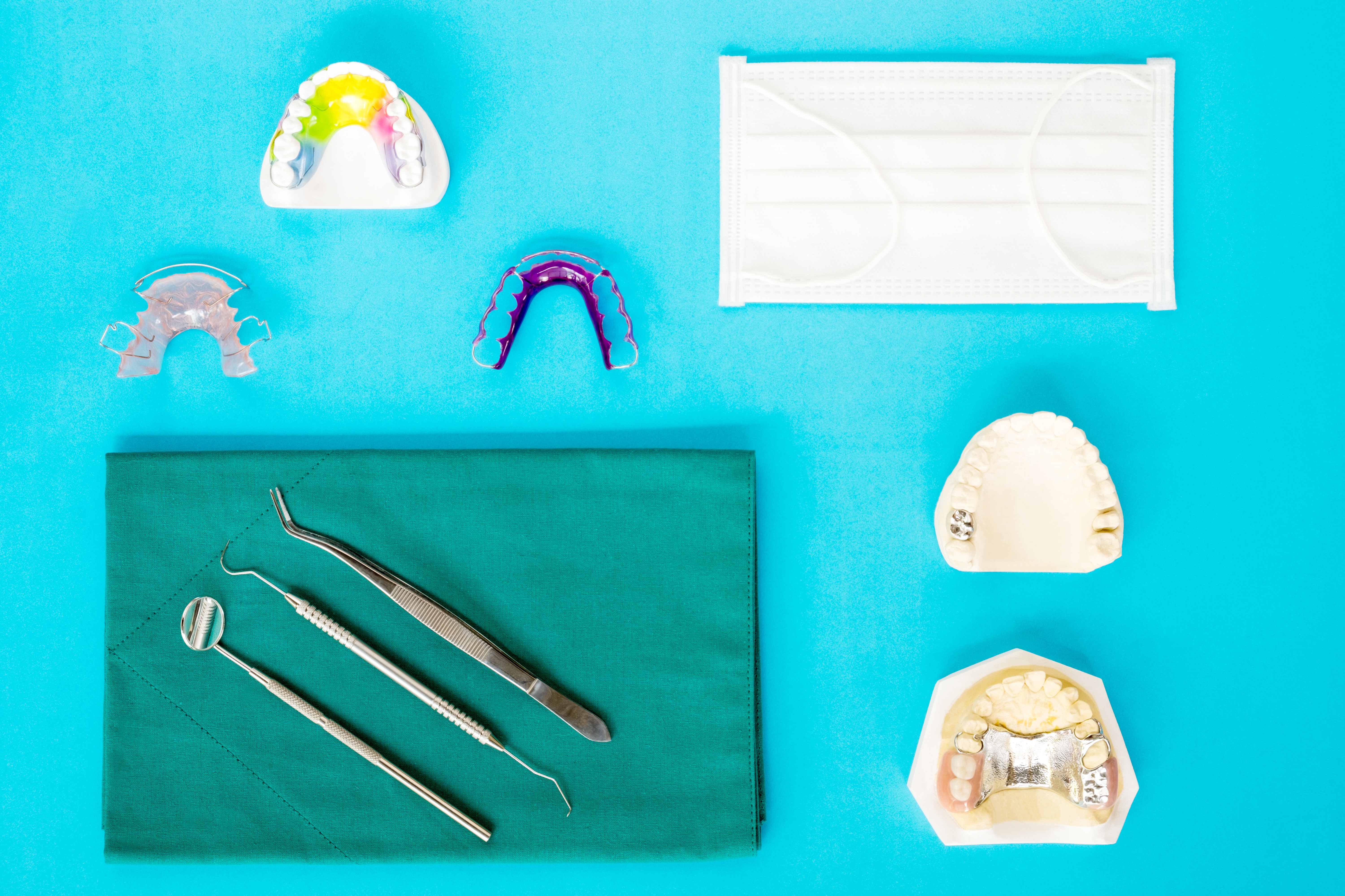 Image of orthodontic tools and multiple versions of retainers.