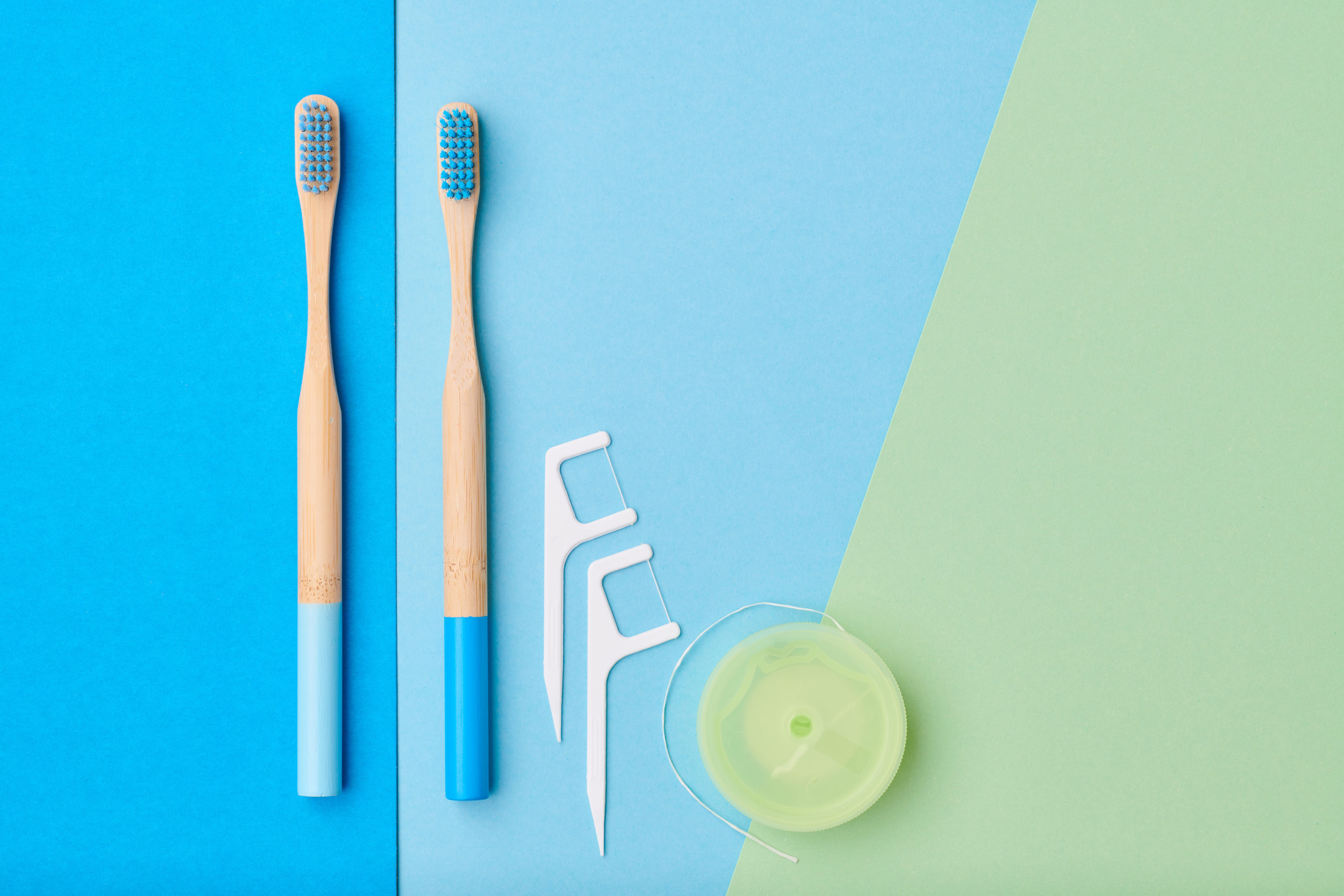 Picture of multiple toothbrushes, floss picks and a roll of dental floss.