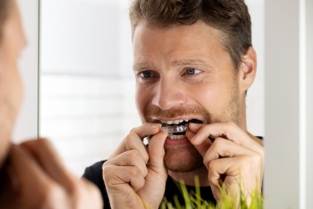 Man going through clear aligner treatment with an orthodontist