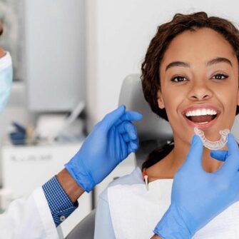 Young woman getting safe and effective aligners at the orthodontic office versus the risks associated DIY treatment.