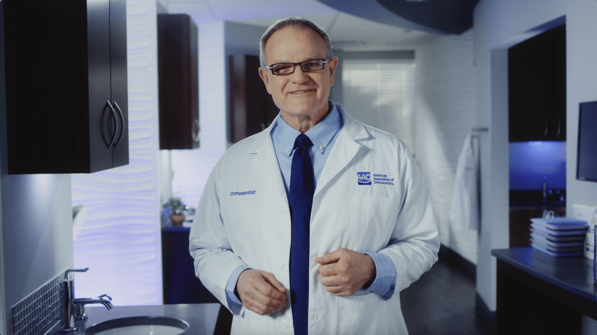 An orthodontist explaining the benefits of aligner treatment to fit into your flexible lifestyle.